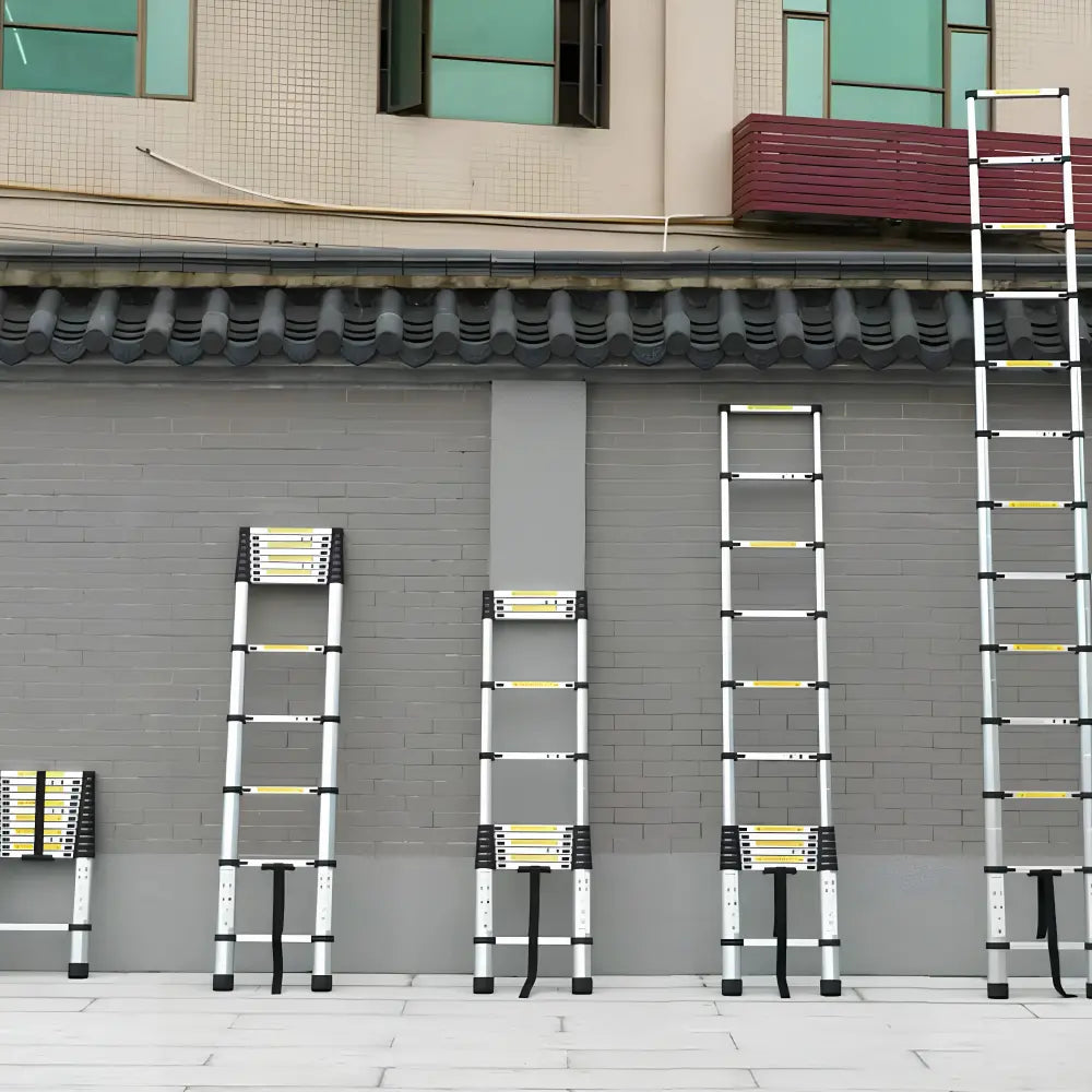 Telescopic ladders extended to different working heights against a wall Image
